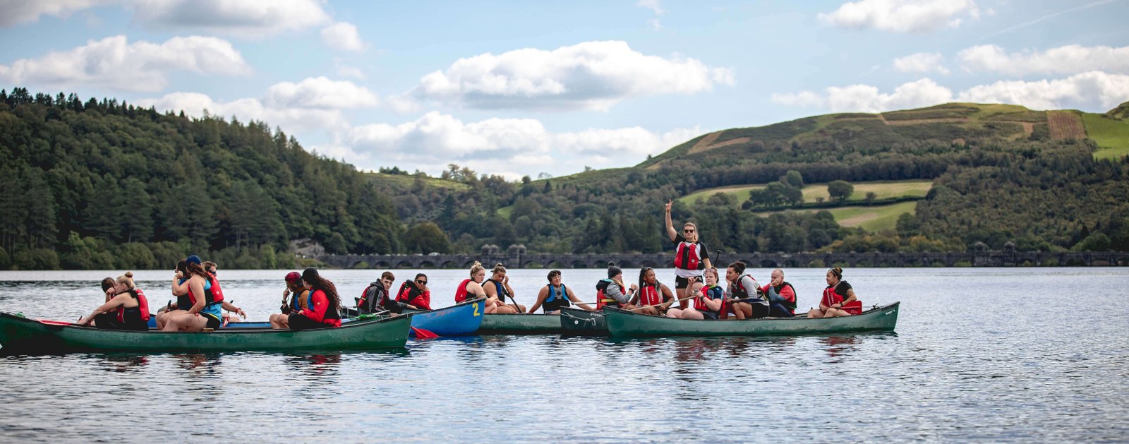 Young people kayaking on lake in Wales